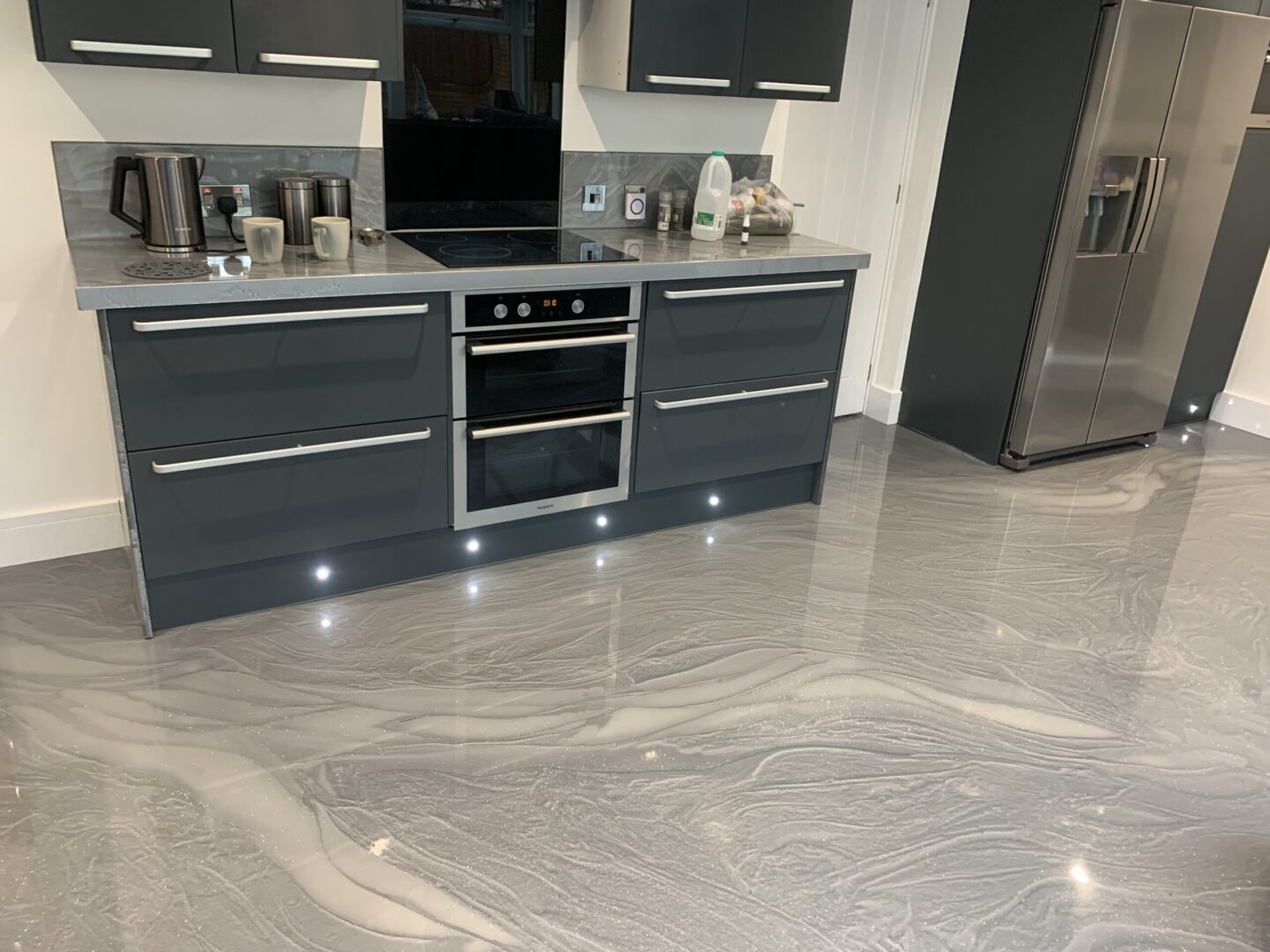 Modern kitchen with sleek grey cabinets.