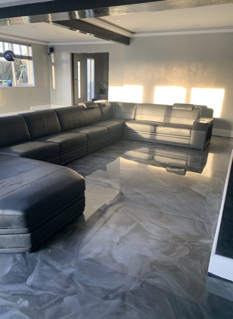 Modern living room with black leather sofas.