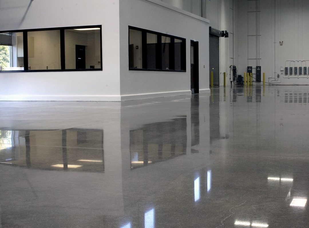 Polished concrete floor in empty warehouse.