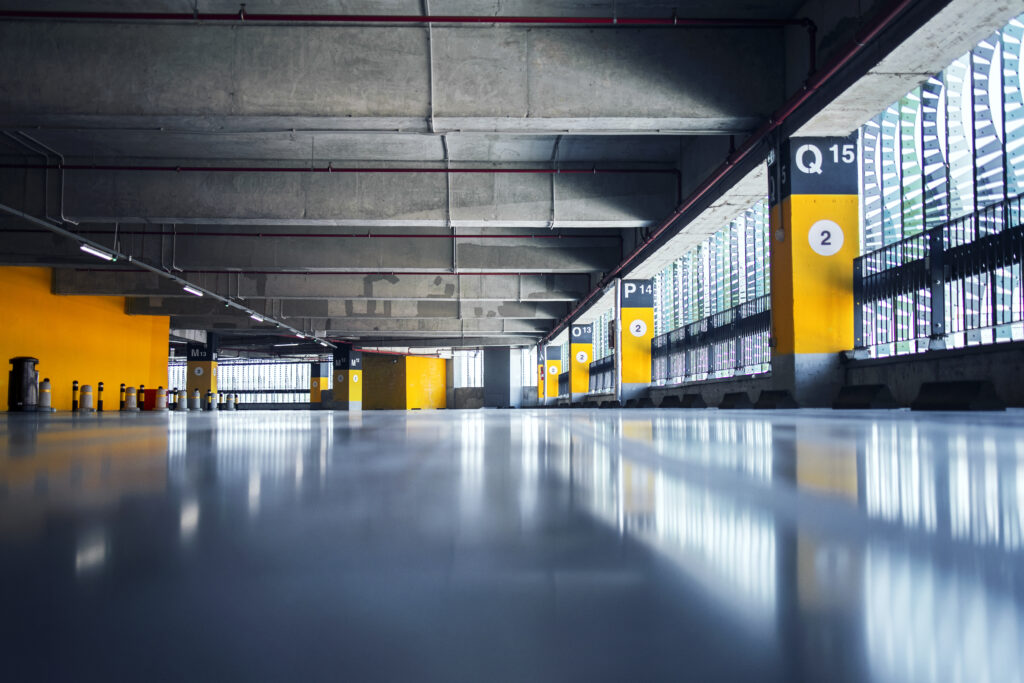 Empty parking garage with yellow pillars.