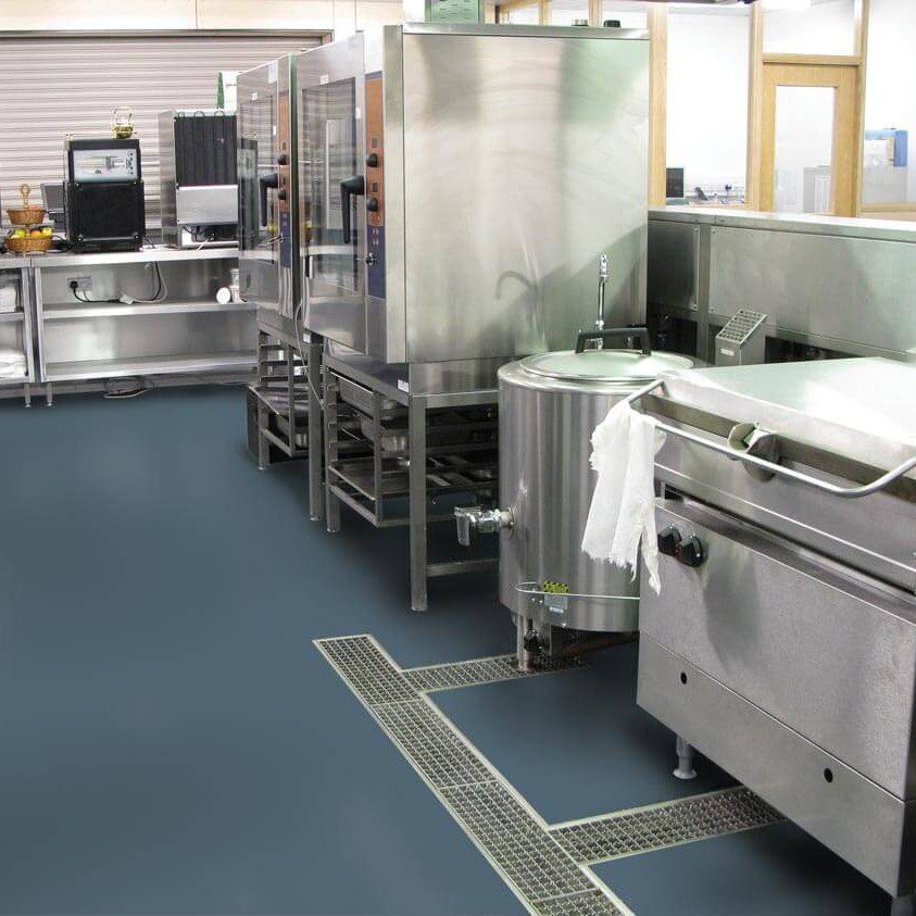 Commercial kitchen with stainless steel appliances.