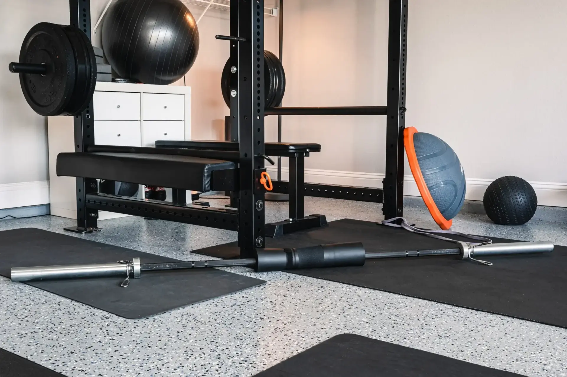 Home gym with weights and exercise equipment.
